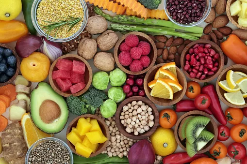 Health food selection with fresh vegetables, fruit, herbs, pulses, seeds and nuts. Super foods concept  very high in antioxidants, fibre, smart carbohydrates, anthocyanins and vitamins.